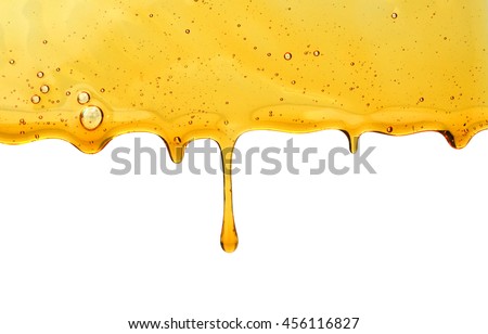Honey wooden dripping with honey dipper isolated on white background