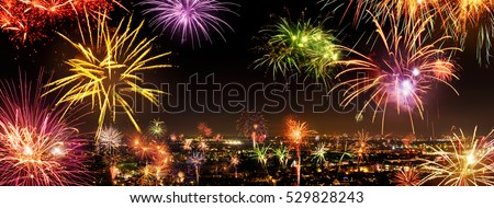 Whole city celebrating the New Year or a national event with lively fireworks, copyspace on the night sky