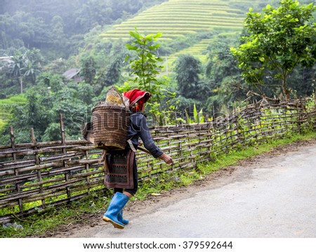SAPA, VIETNAM - SEP 4: Hmong woman going to small market at September 4, 2015 in Sapa, Lao Cai, VIetnam.