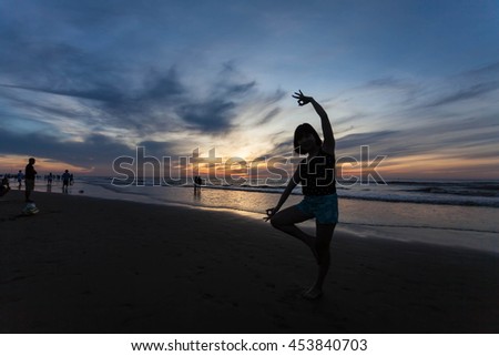 Thanh Hoa, Vietnam , Aug 13 2015 , Young healthy woman practicing yoga on the beach at sunset