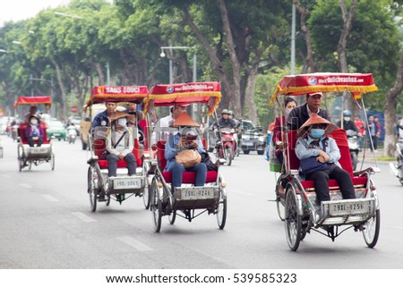 Hanoi, Vietnam, November 25 2016: Life in vietnam- Cyclo beside Sword lake in hanoi, vietnam. Cyclo is the tourist's farvourite vehicle transportation in vietnam