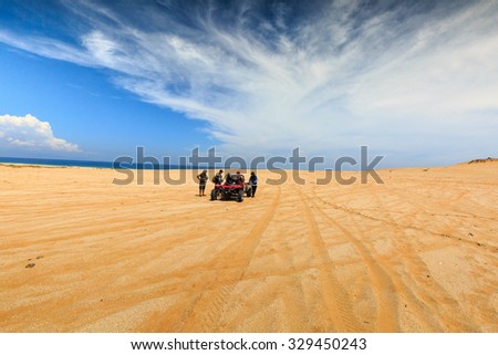 Ninh Thuan province, Vietnam - June 11, 2015: A group of tourists prepared to explore the sand dunes at Mui Dinh the seaside, Binh Thuan Province by coach terrain vehicles