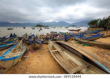 Ninh Thuan Province, Vietnam - February 27, 2016: Boats at anchor at a fishing village in Ninh Thuan coast with cloudy weather