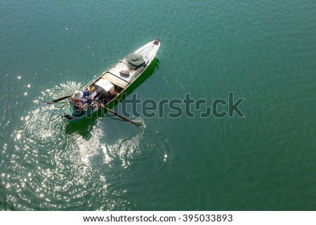 Tri An Lake, Dong Nai Province, Vietnam - March 6, 2016: A fisherman's boat on the lake in the early morning. This is a fisherman who lives in the fishing village of Tri An Lake