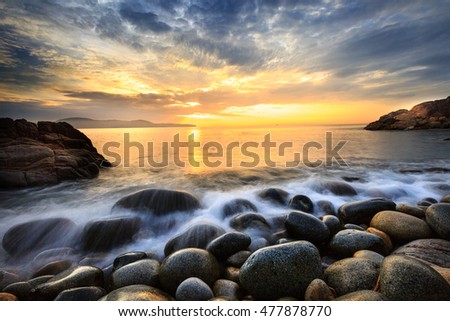 Long exposure of sea and stones, beautiful sunrise in Quy Nhon city, Vietnam
