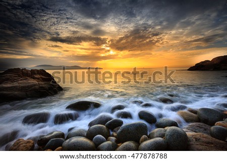Long exposure of sea and stones, beautiful sunrise in Quy Nhon city, Vietnam