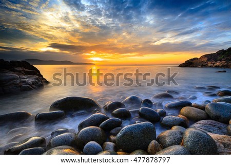 Long exposure of sea and stones, beautiful sunrise in Quy Nhon city, Vietnam