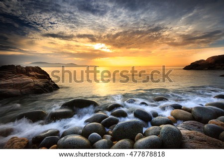 Long exposure of sea and stones, beautiful sunrise in Quy Nhon city, Vietnam