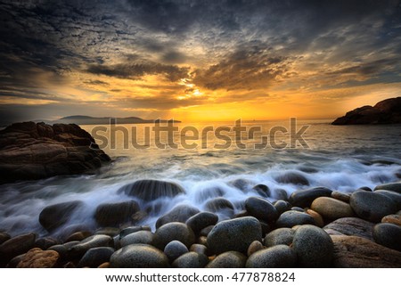 Long exposure of sea and stones, beautiful sunrise in Quy Nhon city, Vietnam