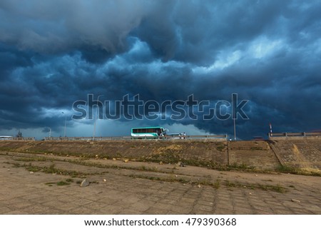 Quy Nhon City, Binh Dinh Province, Vietnam - August 27, 2016: Images buses parked to await tourists at the same time a storm with dark clouds are pulling ahead. danger and impressive