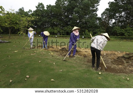 Flamingo Dai Lai, Vinh Phuc province, Vietnam - October 13, 2016 : The female workers who are working with the rudimentary tools at Flamingo Dai Lai resort of Vinh Phuc Province, Vietnam
