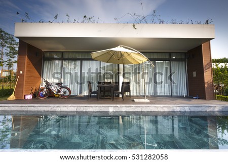 Flamingo Dai Lai, Vinh Phuc province, Vietnam - October 12, 2016 : the living room of a villa overlooking the beautiful pool at Flamingo Dai Lai resort of Vinh Phuc Province, Vietnam