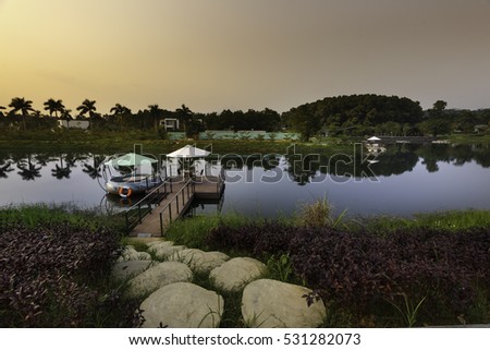 Flamingo Dai Lai, Vinh Phuc province, Vietnam - October 13, 2016 : walking path by stones to the pier on lake in Flamingo resort with dramatic sky at Flamingo Dai Lai resort of Vinh Phuc Province