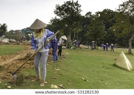 Flamingo Dai Lai, Vinh Phuc province, Vietnam - October 13, 2016 : The female workers who are working with the rudimentary tools at Flamingo Dai Lai resort of Vinh Phuc Province, Vietnam
