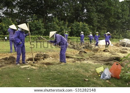 Flamingo Dai Lai, Vinh Phuc province, Vietnam - October 13, 2016 : The female workers who are working with the rudimentary tools at Flamingo Dai Lai resort of Vinh Phuc Province, Vietnam