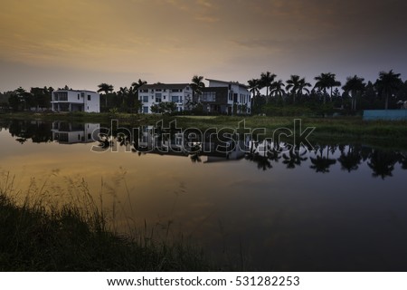 Flamingo Dai Lai, Vinh Phuc province, Vietnam - October 11, 2016 : calm lake reflection at sunset at Flamingo Dai Lai resort of Vinh Phuc Province, Vietnam