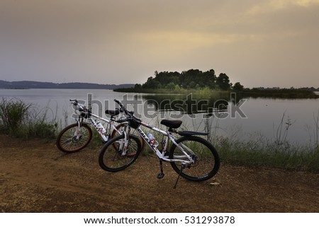 Flamingo Dai Lai, Vinh Phuc, Vietnam - October 10, 2016: Two bicycles beside the lake at sunset