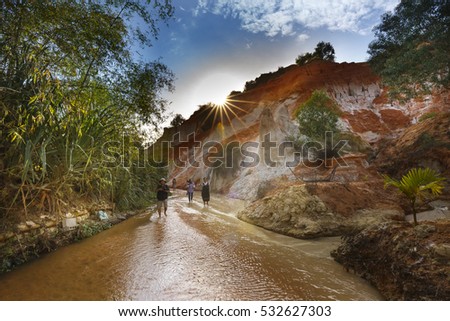 Mui Ne, Phan Thiet city, Vietnam - November 27, 2016 : tourists so excited to be walking on feet in the Red Stream ( it also named Fairy Stream) located near the beach of Mui Ne, Binh Thuan Province