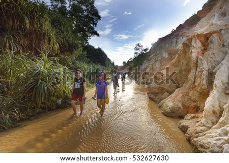 Mui Ne, Phan Thiet city, Vietnam - November 27, 2016 : tourists so excited to be walking on feet in the Red Stream ( it also named Fairy Stream) located near the beach of Mui Ne, Binh Thuan Province
