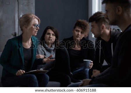 Therapist talking with patients of rehab centre