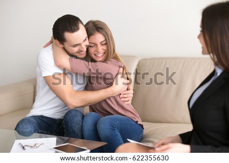 Young Smiling Couple Making First Mortgage Payment Getting Keys And Access To New Home Young Smiling Couple Making First Mortgage Payment Getting Keys And Access To New Home