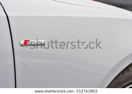 PRAGUE, THE CZECH REPUBLIC, 18.12.2016 - Closeup of new white car Audi Q7 parking in front of car dealership Audi