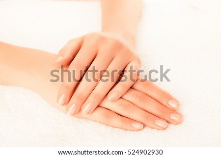 Woman's hands with beautiful manicure isolated on white background.