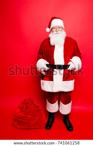Funny santa in headwear, costume, white gloves brings a lot of gifts for kids, ready, prepared, sale promotion concept. Holly jolly x mas festive noel miracles and magic time! Bag on the floor