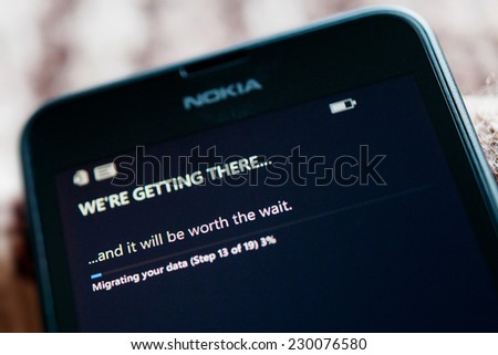LONDON, UNITED KINGDOM - NOVEMBER 9, 2014: Nokia Lumia smartphone first run with message We're Getting There on the screen. Microsoft has announced that it will stop using Nokia branding