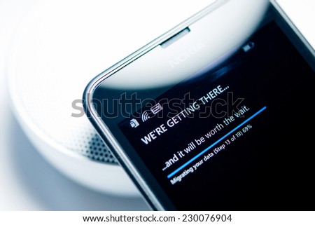 LONDON, UNITED KINGDOM - NOVEMBER 9: Nokia Lumia smartphone windows phone with We're Getting There migrating data status bar percentage. Microsoft has announced that it will stop using Nokia branding