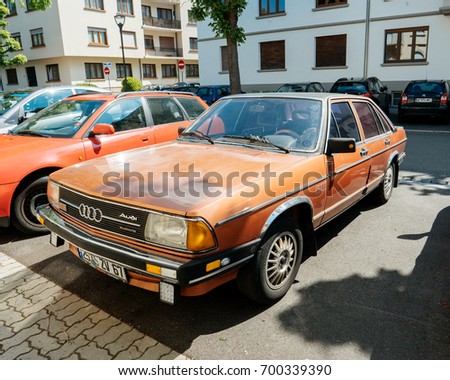 PARIS, FRANCE - APR 28, 2017: Vintage AUDI 100 orange color parked on French street. The Audi 100 and Audi 200 are four-door, front-engine, front- or all-wheel drive full-size/executive sedans