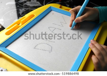 photo of a kid drawing on a magnetic drawing board education process concept learning - Kid Drawing Picture photo of a kid drawing on a magnetic drawing board education process concept learning - Kid Drawing Picture