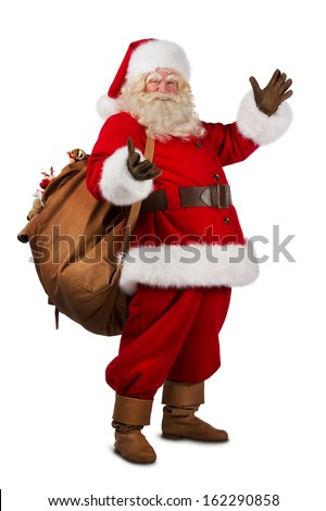 Real Santa Claus carrying big bag full of gifts, isolated on white background