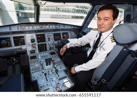 Boryspil, Ukraine - JUNE 01, 2017: Airline pilot at work in the cockpit. Airbus A320 cockpit. Airplane at the airport.