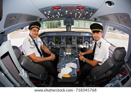 Kyiv, Ukraine - SEPTEMBER 12, 2017: Airline pilots at work in the cockpit. Embraer ERJ-190 cockpit. Airplane at the airport.
