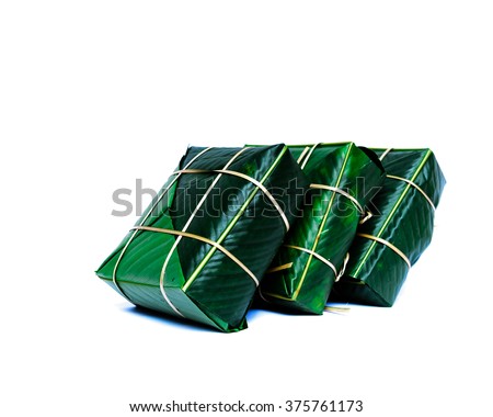 Uncooked Vietnamese Chung Cake isolated on white. It??s a square glutinous sticky rice cake, stuffed with pork meat, green beans and wrapped in bamboo leaf. Traditional Vietnamese New Year (Tet) food.
