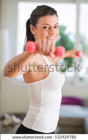 Woman Exercising With Dumbbells, Indoors