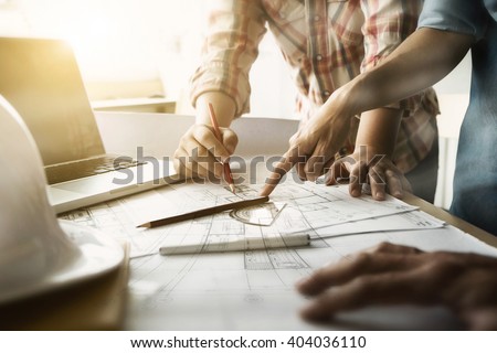 Image of engineer meeting for architectural project. working with partner and engineering tools on workplace vintage tone.