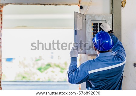 Technician checks fire panel in data center