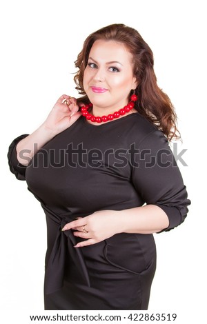 stock photo beautiful cheerful busty brunette in a black dress standing isolated on white background 422863519