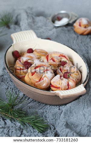 Homemade buns with raspberry jam. Sweet homemade Christmas baking. Winter decor. Winter, Christmas, New Year's still life. Cozy food.