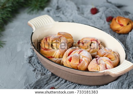 Homemade buns with raspberry jam. Sweet homemade Christmas baking. Winter decor. Winter, Christmas, New Year's still life. Cozy food.