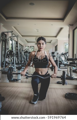 https://thumb1.shutterstock.com/display_pic_with_logo/2934415/591969764/stock-photo-asian-woman-performing-deadlift-exercise-with-weight-bar-confident-young-woman-doing-weight-591969764.jpg