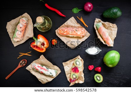 Fresh spring Roll, Vietnamese food on black background. Flat lay, top view. Salad spring roll and ingredients