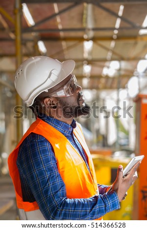 Profiled African american engineer at work using tablet computer
