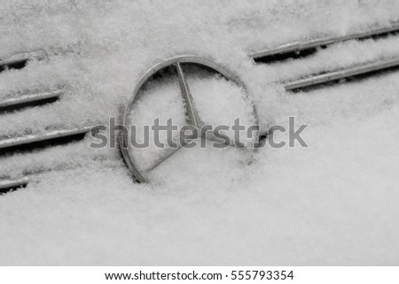 Berlin, Germany - January 11, 2016: frozen Mercedes logo. Mercedes-Benz is automobile manufacturer and division of German company Daimler AG. The brand is known for luxury vehicles, coaches and trucks