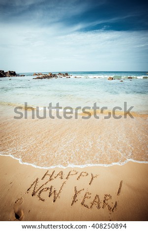 Happy New Year text on the sea beach. Retro vintage.