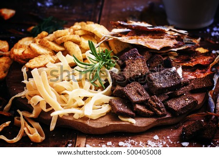 Dried fish and crackers. Vintage wooden background, selective focus