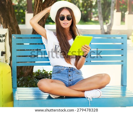 http://thumb1.shutterstock.com/display_pic_with_logo/3026723/279478328/stock-photo-closeup-of-happy-woman-in-glasses-using-tablet-pc-in-the-park-young-woman-wearing-stylish-hipster-279478328.jpg
