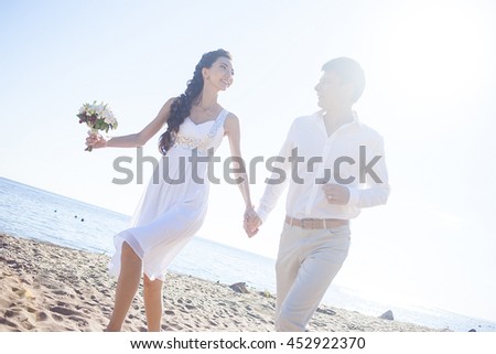 https://thumb1.shutterstock.com/display_pic_with_logo/302776/452922370/stock-photo-just-married-happy-couple-running-on-a-sandy-beach-452922370.jpg